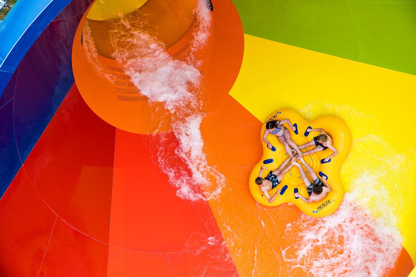 People riding the Tsunami triple funnel waterslide