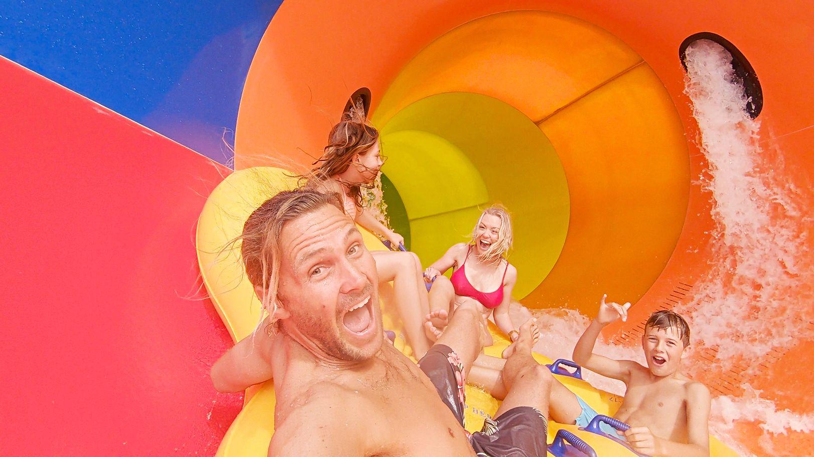A family riding the Tsunami triple funnel waterslide